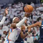 Oklahoma City Thunder player drives to the basket against Minnesota Timberwolves defenders on May 26, 2025.