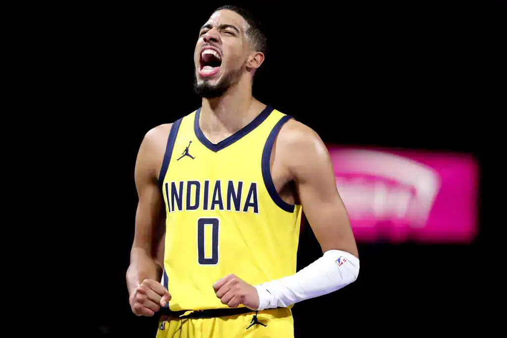 New York Knicks vs Indiana Pacers Picks and Predictions May 29th 2025 2 A basketball player wearing a yellow and blue Indiana jersey celebrates, showcasing determination and enthusiasm on the court.