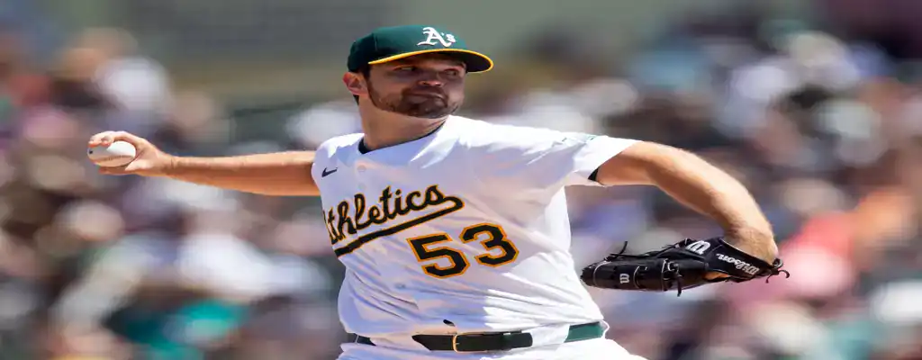 Toronto Blue Jays vs Oakland Athletics Picks and Predictions May 31st 2025 2 Oakland Athletics pitcher throws during a game in bright daylight, wearing a white jersey and green cap.