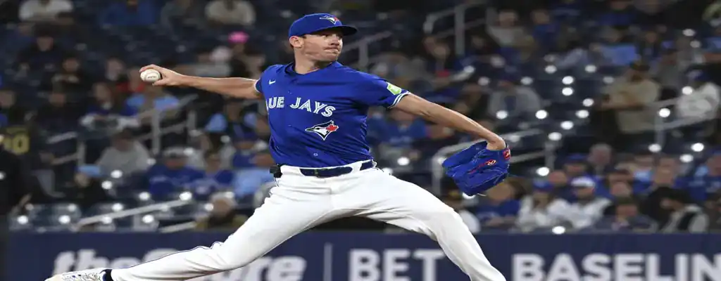 Toronto Blue Jays vs Oakland Athletics Picks and Predictions May 31st 2025 3 Toronto Blue Jays pitcher winds up to throw a pitch during a game, wearing a blue jersey and white pants.