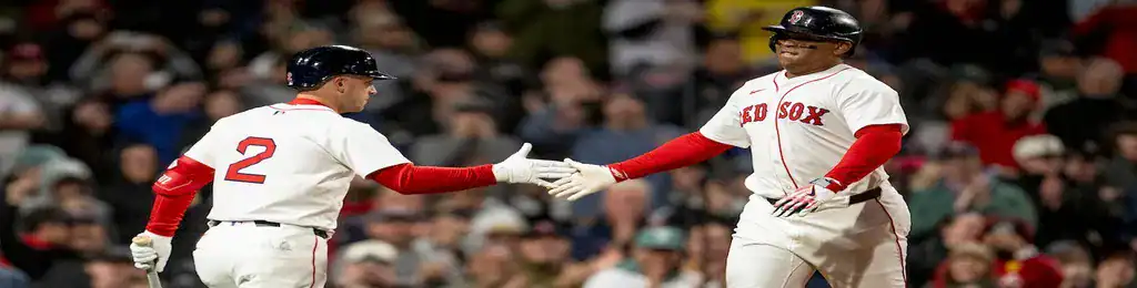 Atlanta Braves vs Boston Red Sox Picks and Predictions May 30th 2025 2 Boston Red Sox players exchanging a high-five on the field during a game at Fenway Park.