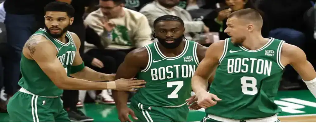 New York Knicks vs Boston Celtics Picks and Predictions May 16th 2025 2 Boston Celtics players Tatum, Brown, and Porzingis regroup during NBA game