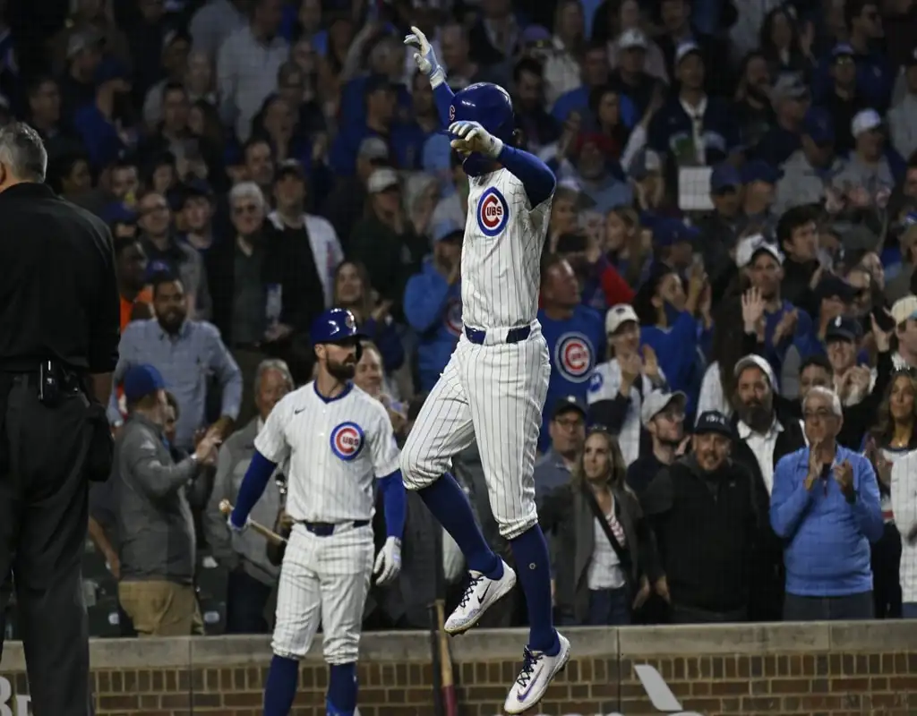 Chicago Cubs player celebrates scoring during May 13, 2025 MLB matchup vs Miami Marlins