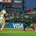 Arizona Diamondbacks first baseman stretches for throw as San Francisco Giants runner approaches during May 13, 2025 MLB game