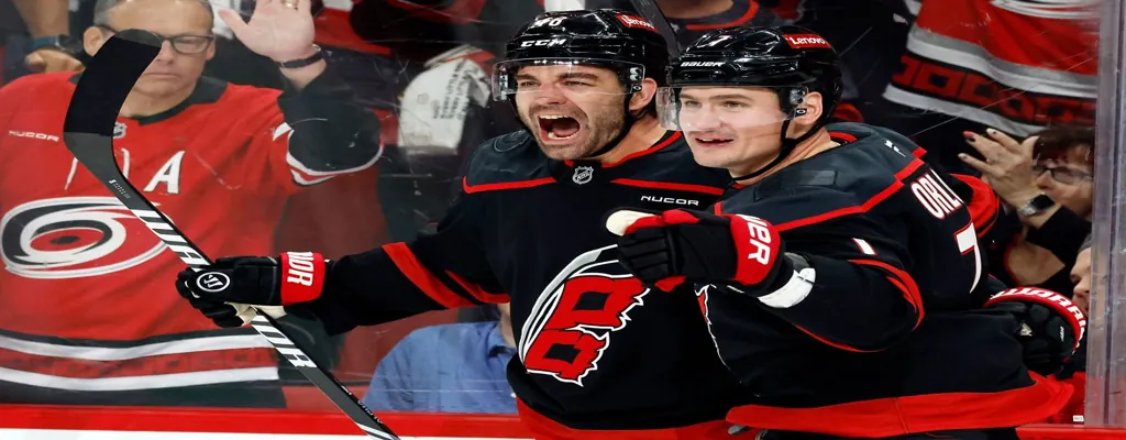 Carolina Hurricanes vs Washington Capitals Picks and Predictions May 12th 2025 3 Hurricanes players celebrate goal in NHL game