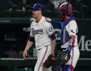 Texas Rangers pitcher and catcher regroup during May 13, 2025 MLB matchup vs Colorado Rockies