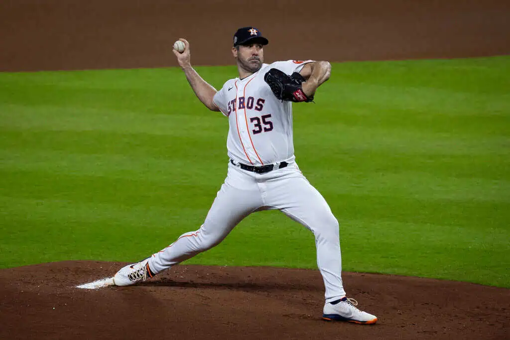 Chicago Cubs vs San Francisco Giants Picks and Predictions May 6th 2025 2 A baseball player in an Astros uniform prepares to pitch on the mound, showcasing a dynamic throwing motion against a green field.