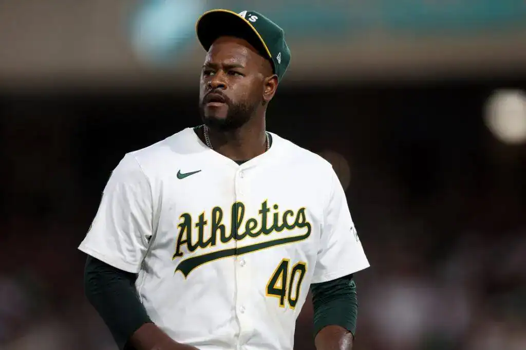 An Oakland Athletics player wearing a number 40 jersey looks on during a game.