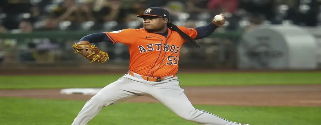 Houston Astros vs Philadelphia Phillies Picks and Predictions June 26th 2025 3 Houston Astros pitcher in orange jersey delivering a pitch during a night game