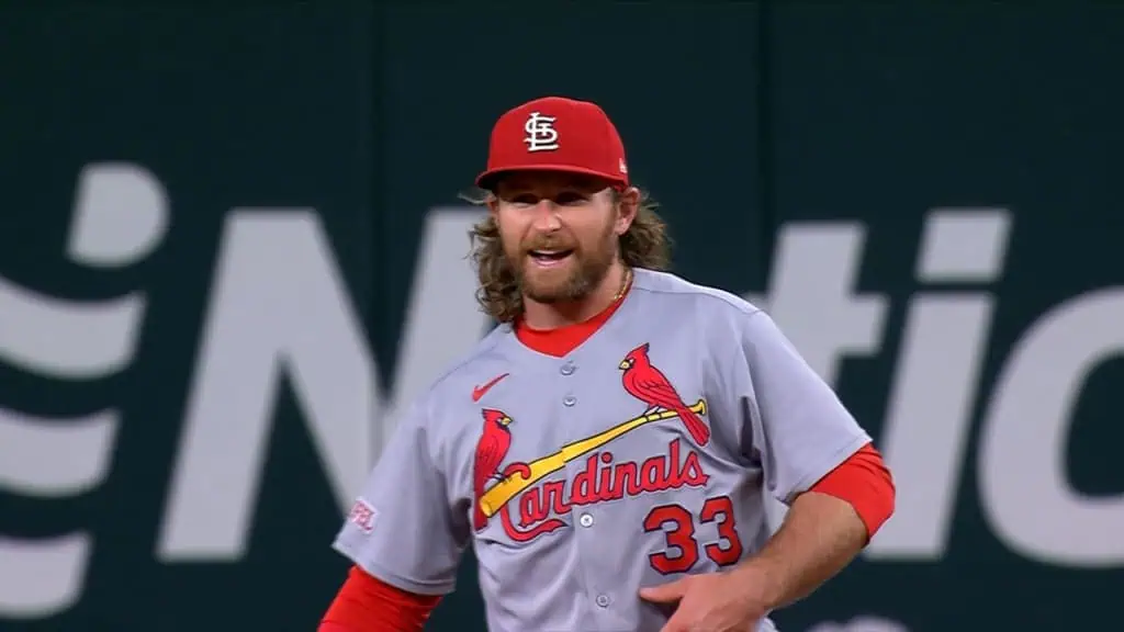 St. Louis Cardinals vs Chicago Cubs Picks and Predictions June 25th 2025 2 A player in a gray St. Louis Cardinals jersey with red accents stands on the field, focused and ready for play, in front of a dark background.