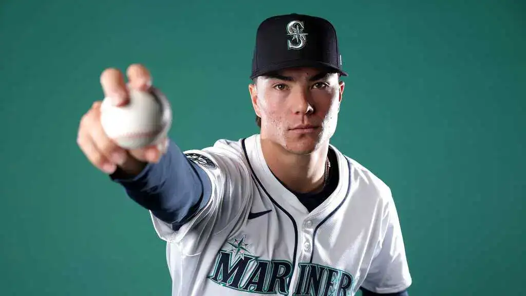 Seattle Mariners vs Boston Red Sox Picks and Predictions June 18th 2025 2 A baseball player in a Mariners jersey poses confidently, gripping a baseball, with a green backdrop highlighting his team spirit.