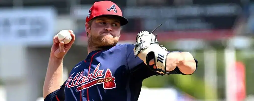 Atlanta Braves vs Colorado Rockies Picks and Predictions June 13th 2025 2 A baseball pitcher in an Atlanta Braves jersey prepares to throw a pitch, gripping a baseball with an intense focus in a sunny stadium.
