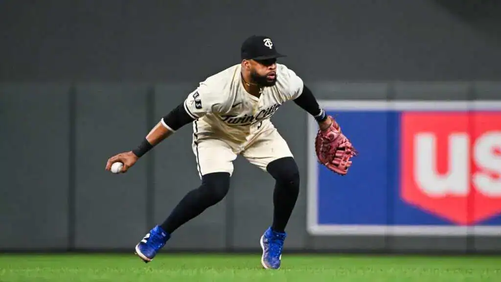 Seattle Mariners vs Cleveland Guardians Picks and Predictions June 13th 2025 2 A baseball player in a white Twins uniform is crouching and preparing to field a ball on a field with a blurred background.