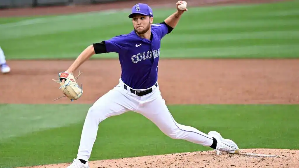 Washington Nationals vs Colorado Rockies Picks and Predictions June 16th 2025 2 A male baseball pitcher in a purple jersey winds up to throw, showcasing athletic form on a well-manicured field.