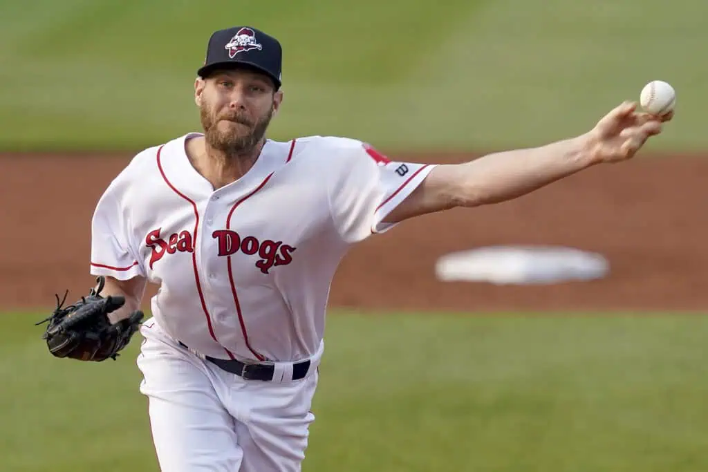 Atlanta Braves vs New York Mets Picks and Predictions June 18th 2025 2 A baseball player in a white jersey with "Sea Dogs" written on it is pitching the ball on a green field during a game.