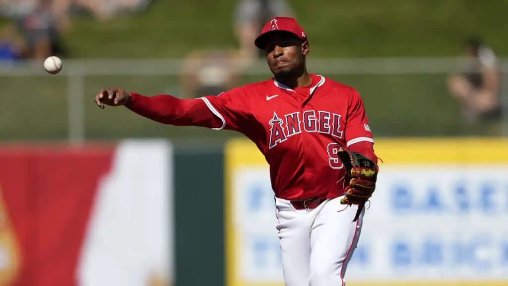 Los Angeles Angels vs Boston Red Sox Picks and Predictions June 25th 2025 2 A baseball player in a red Angels uniform throws a baseball, with fans in the background enjoying the game during daylight.