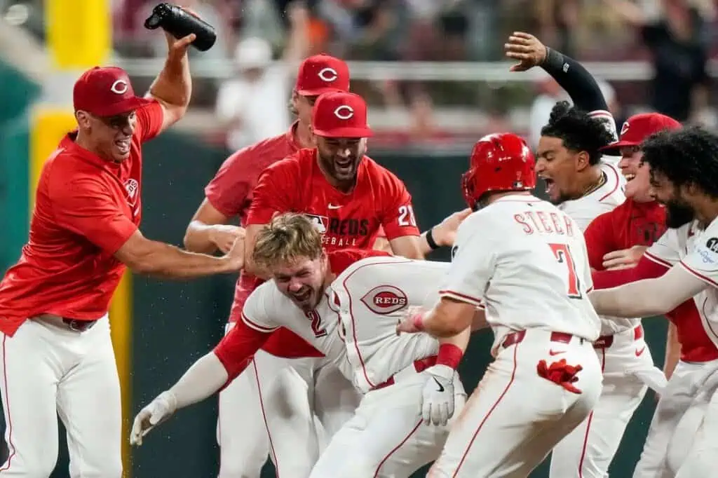 A chaotic moment unfolds as Cincinnati Reds players engage in an intense celebration on the field, showcasing team spirit and excitement.