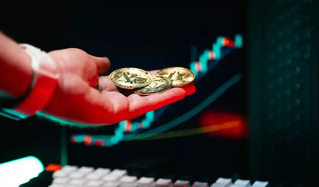 Hand holding cryptocurrency coins in front of a rising financial chart, symbolizing crypto betting