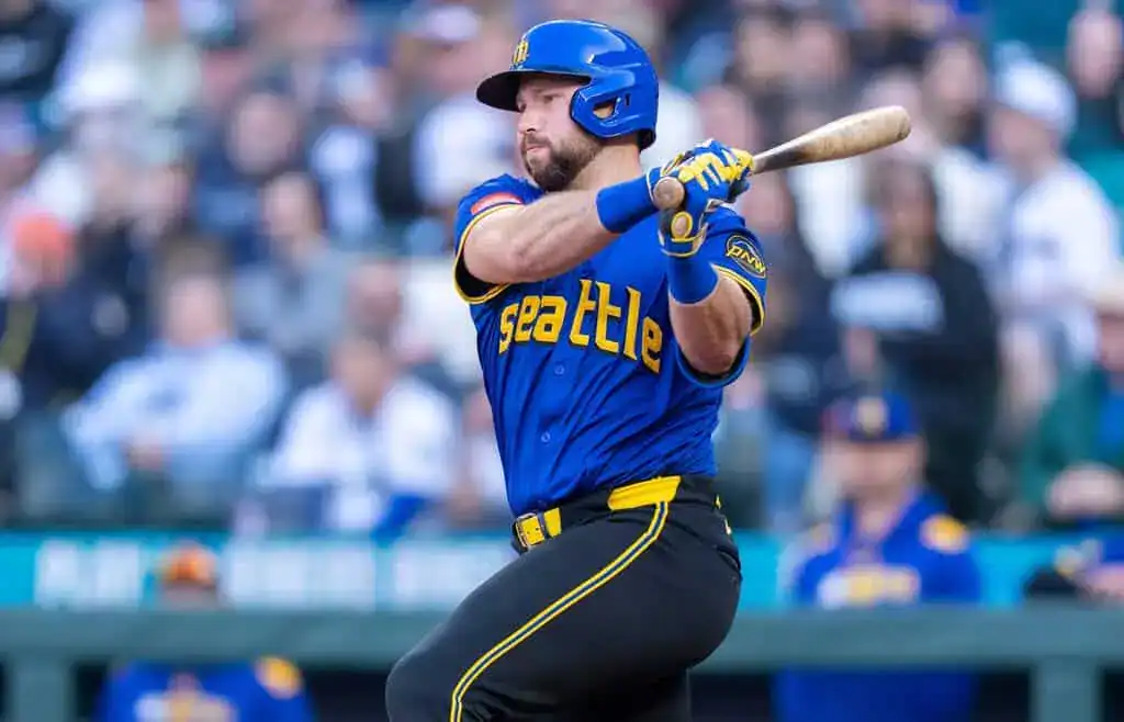 New York Yankees vs Cleveland Guardians Picks and Predictions June 5th 2025 2 A baseball player in a blue Seattle jersey swings a bat, with a cheering crowd blurred in the background.