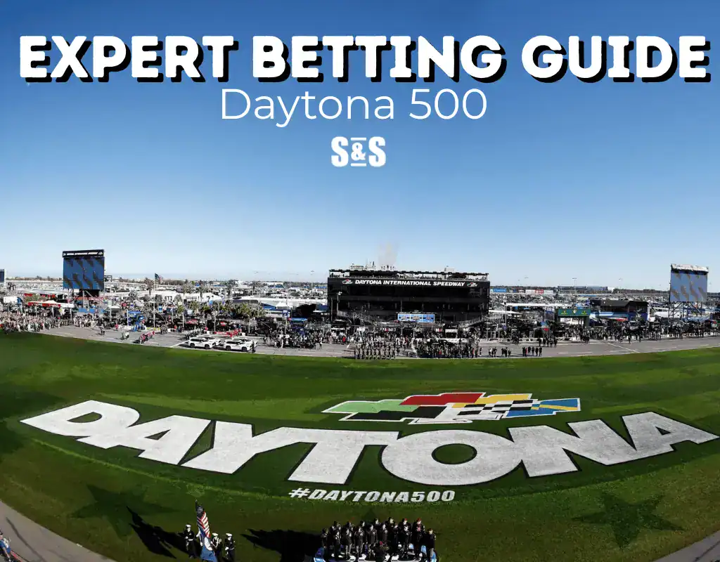 Aerial view of the Daytona International Speedway, featuring large "DAYTONA" lettering and banner for the Expert Betting Guide.