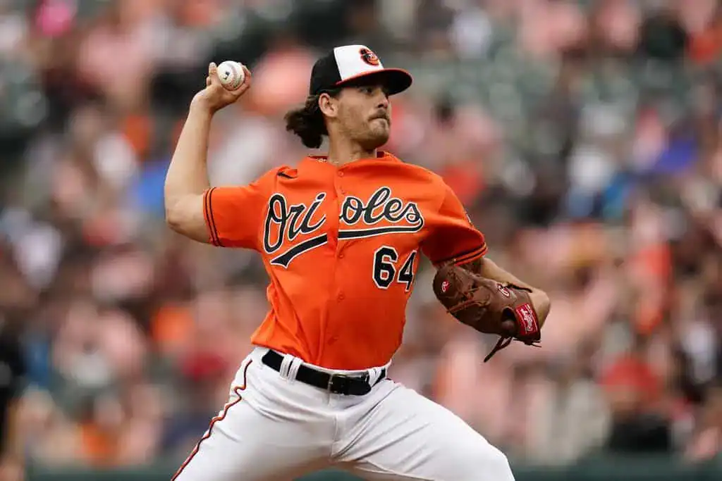 Baltimore Orioles vs Los Angeles Angels Picks and Predictions June 13th 2025 2 A pitcher in an Orioles jersey winds up to throw a baseball on the field, showcasing an intense game atmosphere.