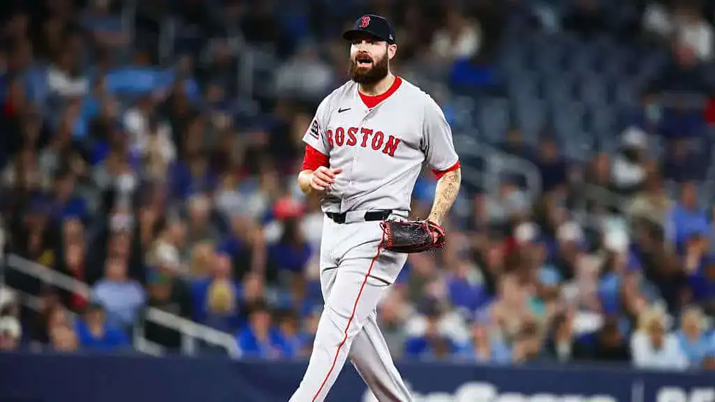 Boston Red Sox vs Tampa Bay Rays Picks and Predictions June 10th 2025 2 A Boston Red Sox player in a gray uniform walks on the field, with a packed stadium of fans in the background.