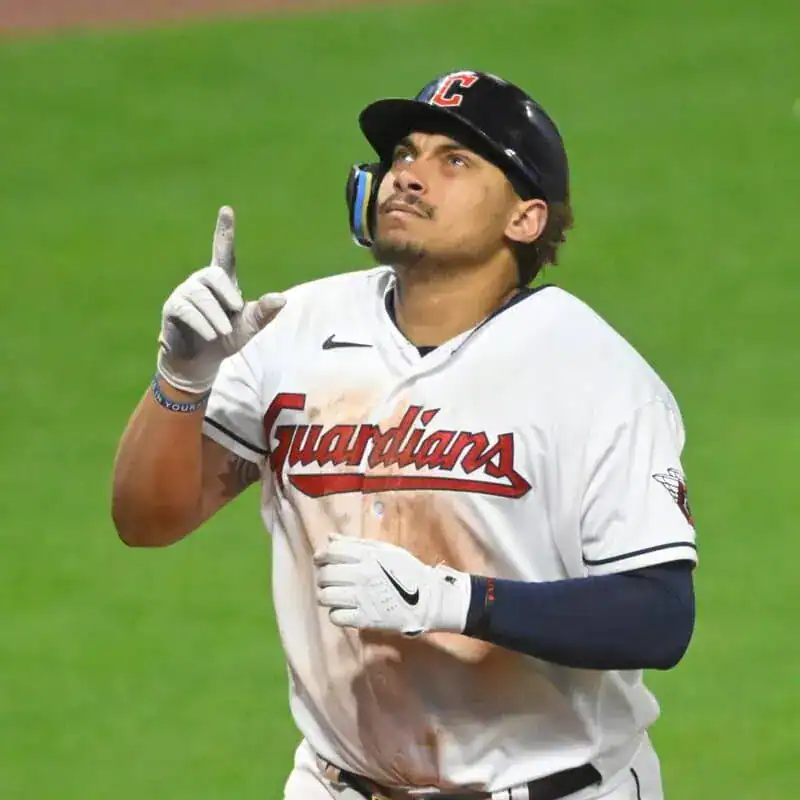 Arizona Diamondbacks vs Seattle Mariners Picks and Predictions June 10th 2025 2 A player in a white baseball jersey of the Guardians celebrates, raising his index finger with dirt stains on his uniform, showcasing excitement.