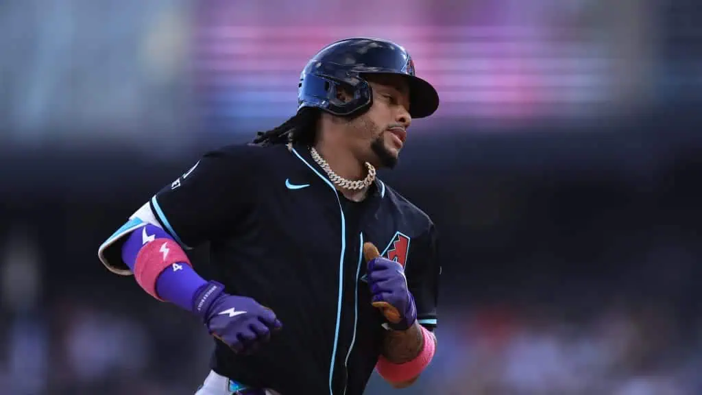 Chicago White Sox vs Arizona Diamondbacks Picks and Predictions June 25th 2025 2 A baseball player in a black jersey with colorful sleeves, wearing a helmet and necklace, runs on the field during a game.