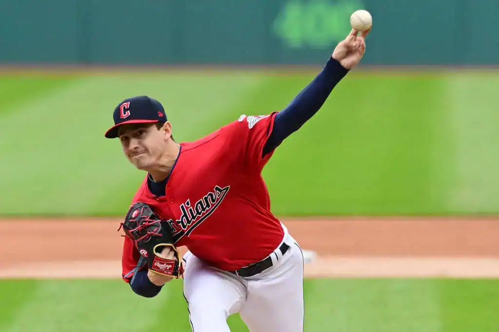 San Francisco Giants vs Cleveland Guardians Picks and Predictions June 18th 2025 2 A baseball player in a red jersey throws a pitch on the field, showcasing a focused athletic stance against a green backdrop.