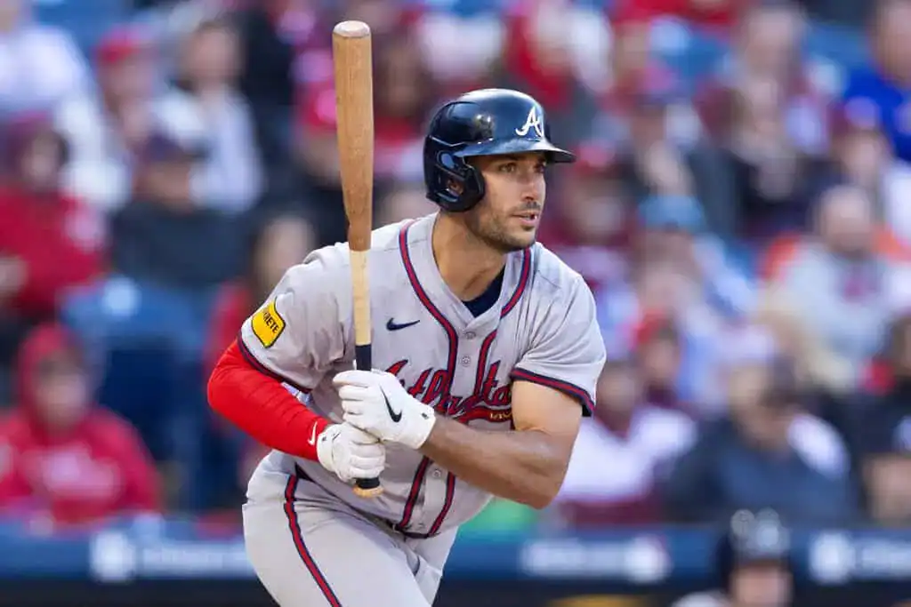 Milwaukee Brewers vs Atlanta Braves Picks and Predictions June 10th 2025 2 A baseball player in a grey uniform and red sleeves prepares to bat, with fans blurred in the background of a stadium.