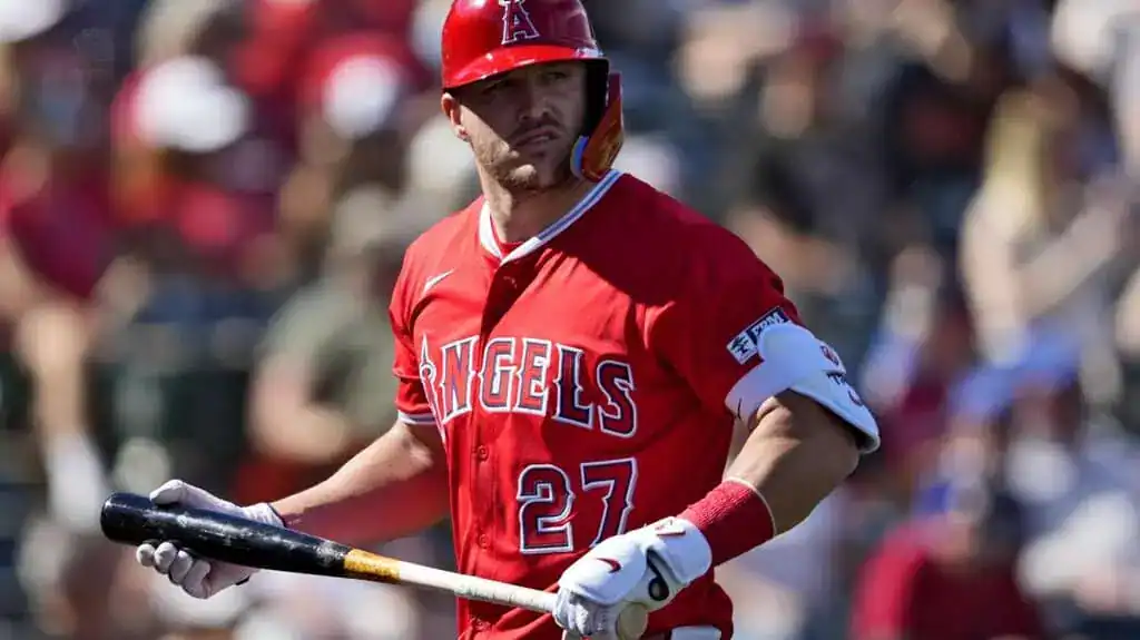 Los Angeles Angels vs Washington Nationals Picks and Predictions June 29th 2025 2 A baseball player in a red Angels uniform stands with a bat in hand, watching the field with fans blurred in the background.