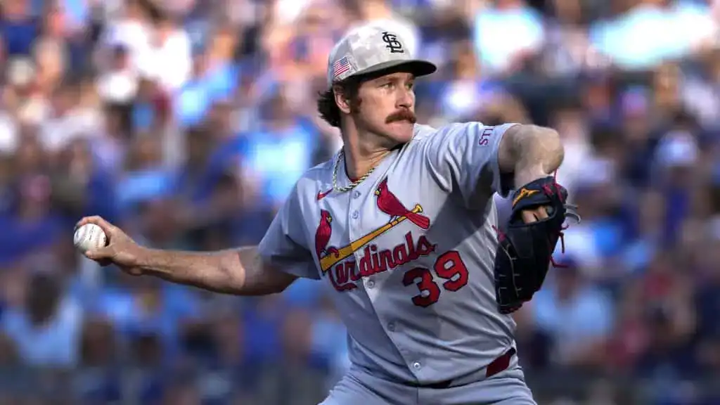 St. Louis Cardinals vs Kansas City Royals Picks and Predictions June 5th 2025 2 A St. Louis Cardinals pitcher in a gray uniform throws a baseball on a sunny day, with a blurred crowd in the background.
