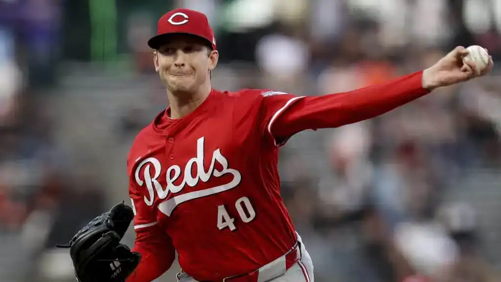 Cincinnati Reds vs Arizona Diamondbacks Picks and Predictions June 6th 2025 2 A baseball pitcher in a bright red Cincinnati Reds jersey winds up to throw a baseball during a game, showcasing athleticism and focus.