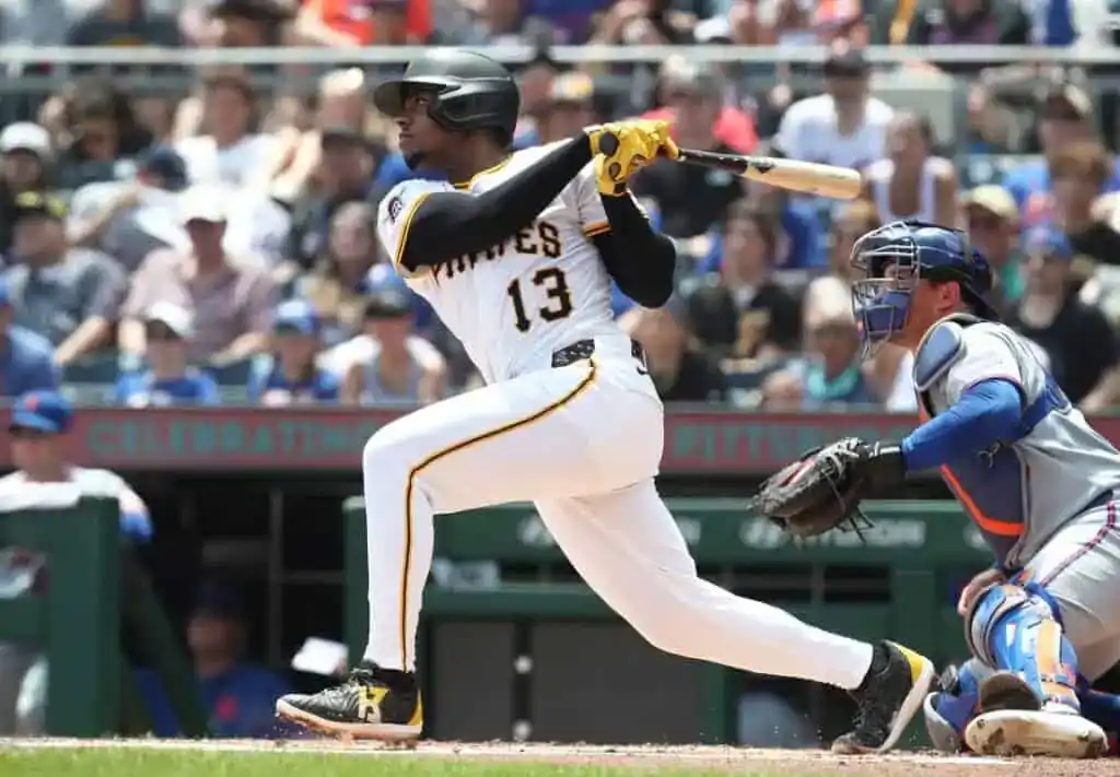 Pittsburgh Pirates player Ke'Bryan Hayes, number 13, swings the bat during a game