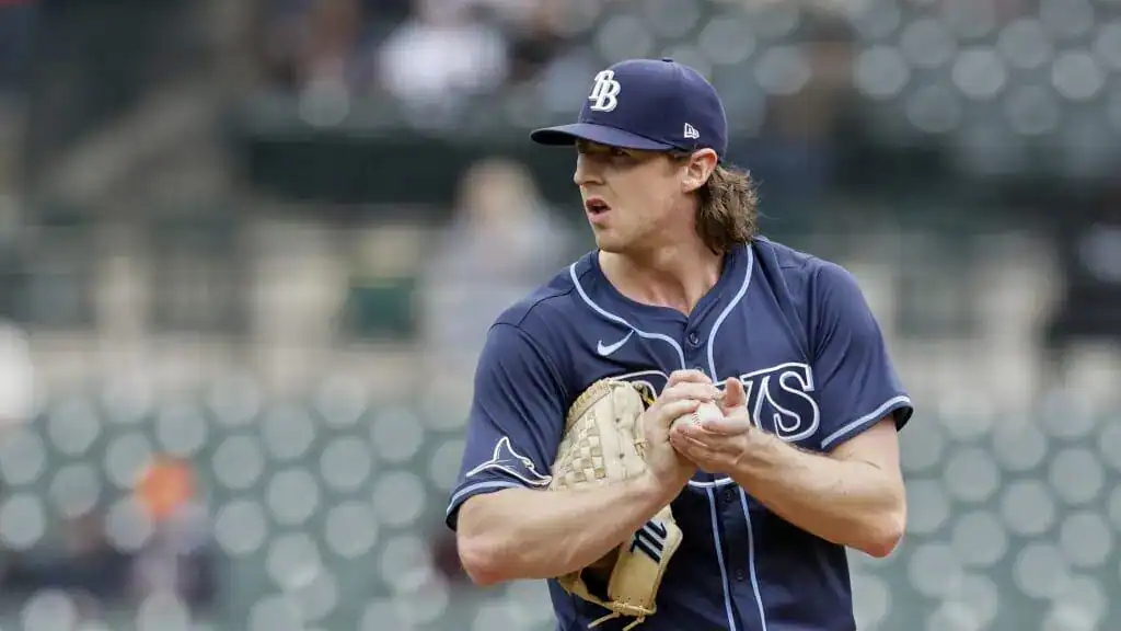 Baltimore Orioles vs Tampa Bay Rays Picks and Predictions June 27th 2025 2 A baseball pitcher in a blue jersey prepares to throw, gripping a glove and looking focused on the game at an empty stadium.