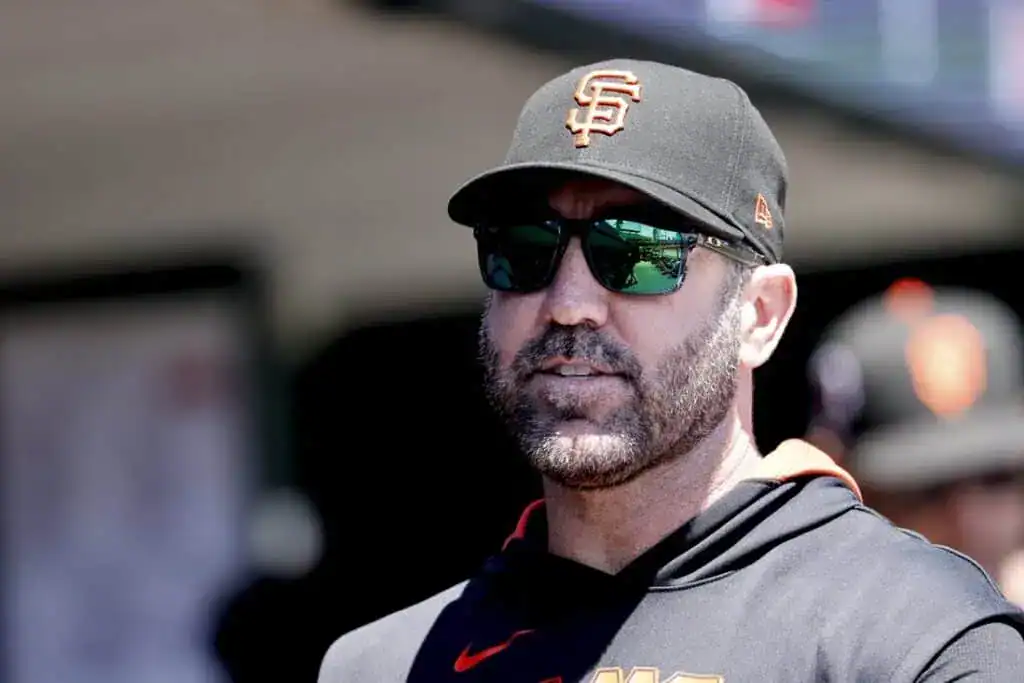 A close-up of San Francisco Giants manager Gabe Kapler wearing a team cap and sunglasses.