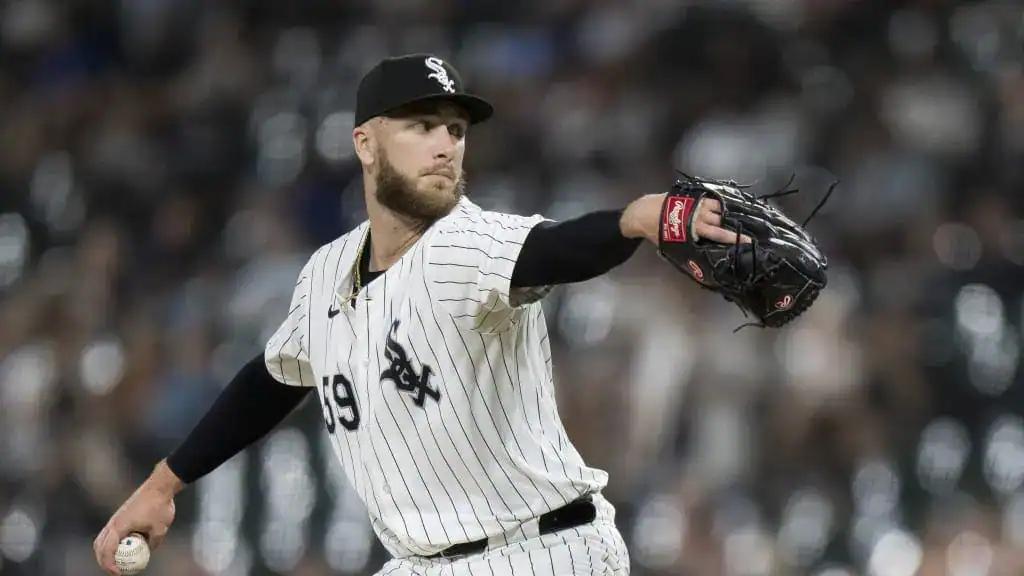Chicago White Sox vs St. Louis Cardinals Picks and Predictions June 18th 2025 2 A baseball player wearing a white pinstripe jersey and cap pitches on the mound, showcasing athletic form against a blurred crowd.