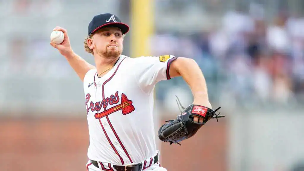 Milwaukee Brewers vs Atlanta Braves Picks and Predictions June 11th 2025 2 A pitcher from the Atlanta Braves winds up to throw a baseball on the field, wearing a white jersey with team colors and logo.