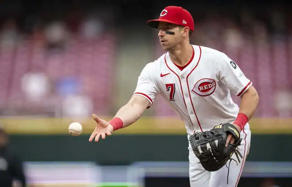 Cleveland Guardians vs Cincinnati Reds Picks and Predictions June 11th 2025 2 A baseball player in a Cincinnati Reds uniform prepares to throw a ball during a game, displaying focused athleticism.