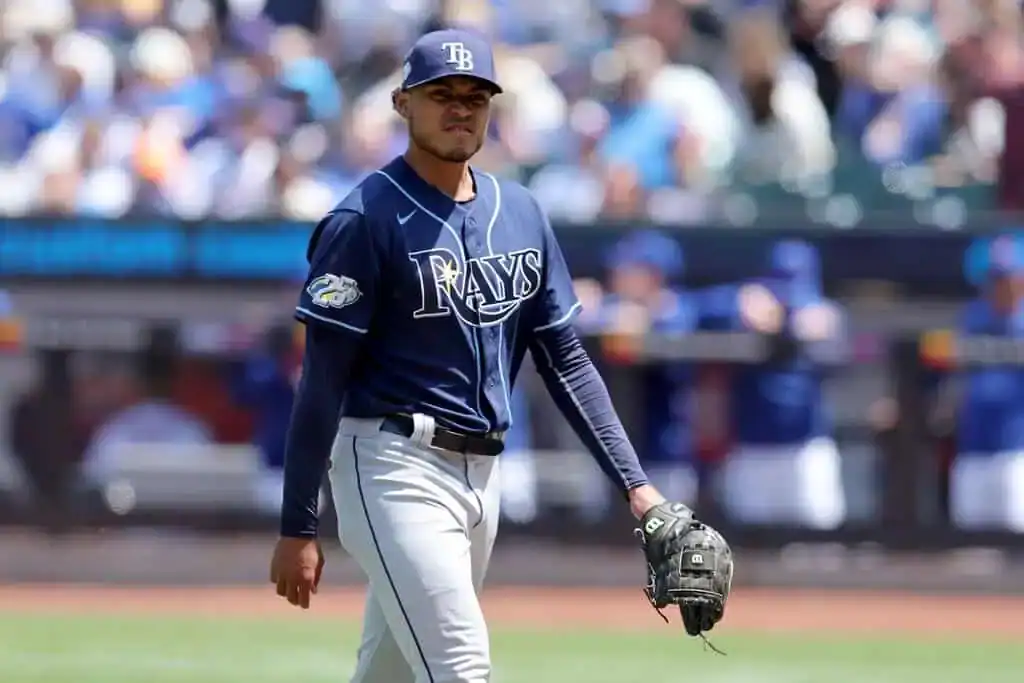 Baltimore Orioles vs Tampa Bay Rays Picks and Predictions June 29th 2025 2 A Tampa Bay Rays player walks on the field during a sunny baseball game, wearing a navy jersey and gray pants