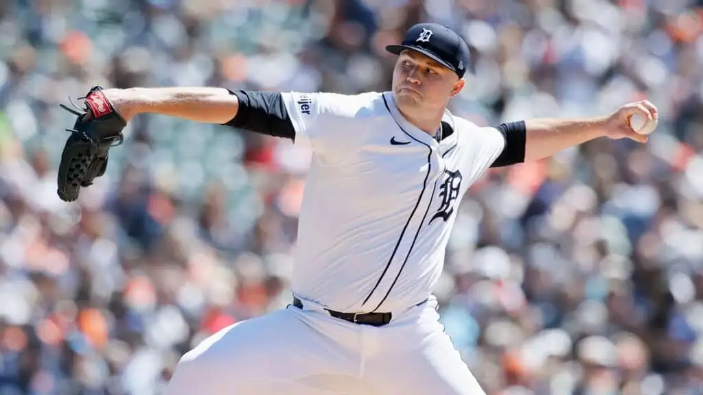 Detroit Tigers vs Pittsburgh Pirates Picks and Predictions June 18th 2025 2 A baseball pitcher in a white Tigers uniform winds up to throw a pitch, with a stadium full of fans in the background.