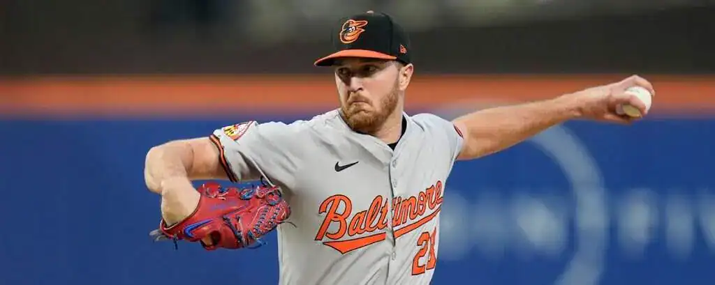 Texas Rangers vs Baltimore Orioles Picks and Predictions June 30th 2025 2 A Baltimore Orioles pitcher in a gray jersey and red glove is preparing to throw a baseball on a baseball diamond.