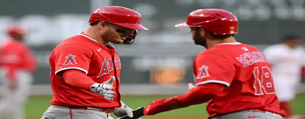 Boston Red Sox vs Los Angeles Angels Picks and Predictions June 4th 2025 1 Los Angeles Angels players celebrate after a successful play, wearing red jerseys and helmets during a baseball game.