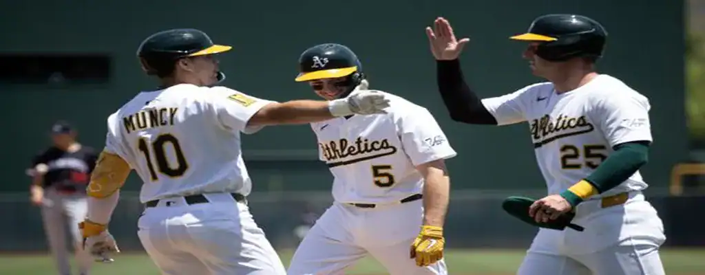 Oakland Athletics players celebrate after scoring a run during an MLB game