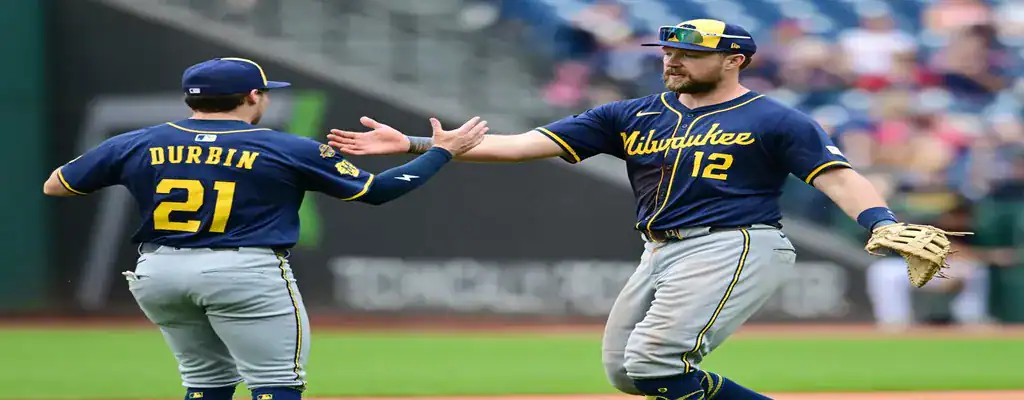 Milwaukee Brewers vs San Diego Padres Picks and Predictions June 7th 2025 3 Milwaukee Brewers players celebrate on the field with a high-five after a game