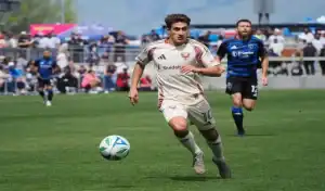 DC United player dribbles ball during game against Chicago Fire FC on June 7, 2025