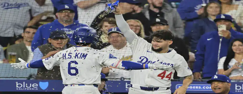 Los Angeles Dodgers vs New York Mets Picks and Predictions June 4th 2025 3 Los Angeles Dodgers players celebrate a run as one player showers another with sunflower seeds, surrounded by cheering fans.