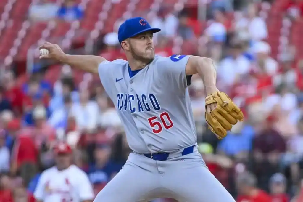 A Chicago Cubs pitcher wearing number 50 throws a pitch during a baseball game.