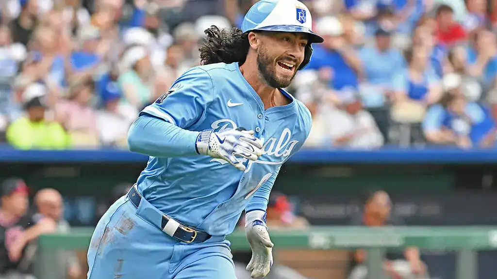 Cincinnati Reds vs San Diego Padres Picks and Predictions June 27th 2025 2 A player in a light blue baseball uniform runs towards home plate, with a crowd cheering in the background.