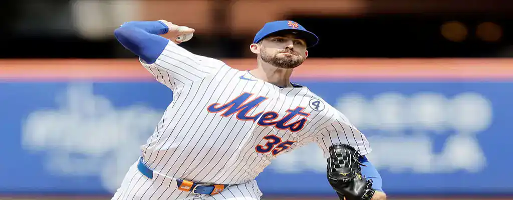 Los Angeles Dodgers vs New York Mets Picks and Predictions June 4th 2025 2 New York Mets pitcher throws a fastball in a home game, wearing the team's white pinstripe uniform and blue cap.